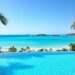 Luxury European resort pool with ocean view.