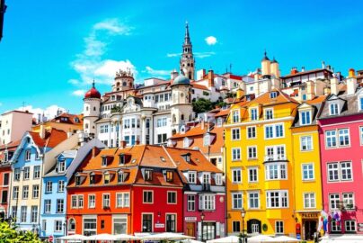 Colorful European city street with cobblestones and historic buildings.