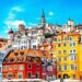 Colorful European city street with cobblestones and historic buildings.