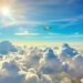 Airplane soaring above clouds towards a distant horizon.