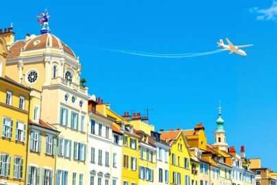 European cityscape with vibrant colors and stylized airplane.