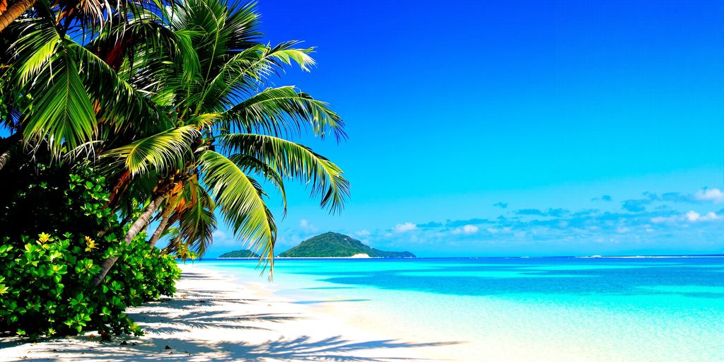 Turquoise water meets white sand on a tropical Caribbean beach.