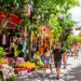 Family exploring a vibrant, colorful foreign market on an affordable trip.