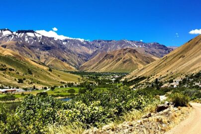 Vibrant Argentinian landscape with mountains and a winding road.