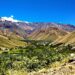 Vibrant Argentinian landscape with mountains and a winding road.