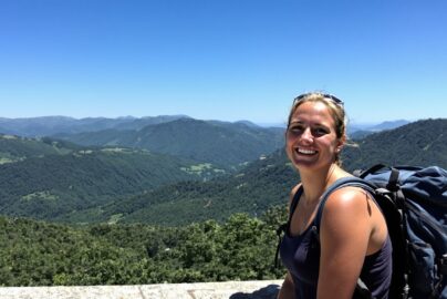 Solo female traveler enjoying a scenic mountain view.