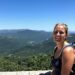 Solo female traveler enjoying a scenic mountain view.