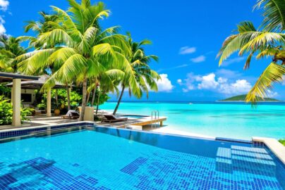 Tropical villa with pool and beach.