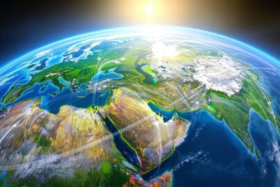 Globe with airplane trails and sunlight.