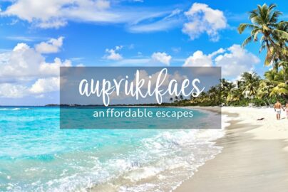 Couple walking on a sunny beach during a weekend getaway.