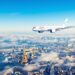 Airplane flying over European landmarks on clear sunny day