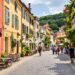 Charming European street with colorful old buildings and cafés.