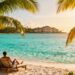 Couple relaxing on a sunny beach with resort.