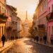 Charming European city street at sunset with colorful buildings.