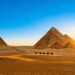 Pyramids of Giza at sunset with camels.