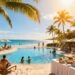 Tropical resort beach with pool and happy vacationers