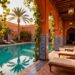 Luxurious Moroccan riad courtyard with pool and palm trees.