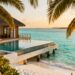 Maldives overwater bungalow with infinity pool and turquoise lagoon.