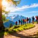 Travelers exploring a scenic mountain vista with snow-capped peaks.