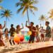 People celebrating at a tropical beach party destination.