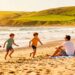 Family enjoying a sunny UK beach holiday in 2026.