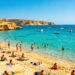 Crowded beach in Malta during peak tourist season.