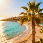 Cyprus beach resort with turquoise water and palm trees.