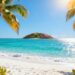 Caribbean beach with turquoise water and palm trees.