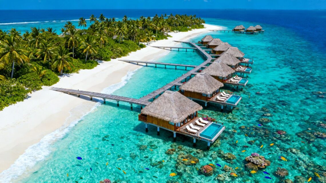 Overwater bungalows in turquoise Maldives lagoon