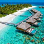 Overwater bungalows in turquoise Maldives lagoon