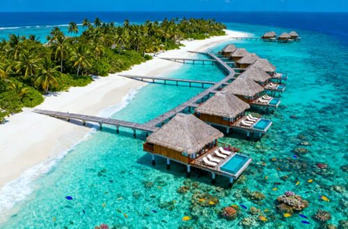 Overwater bungalows in turquoise Maldives lagoon