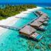 Overwater bungalows in turquoise Maldives lagoon