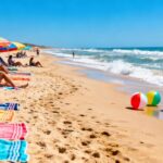 Summer beach with umbrellas, towels, and beach balls.