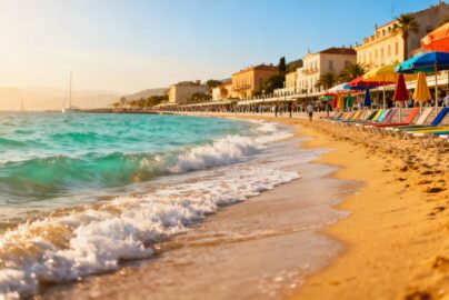 Sunny European beach with clear blue water.