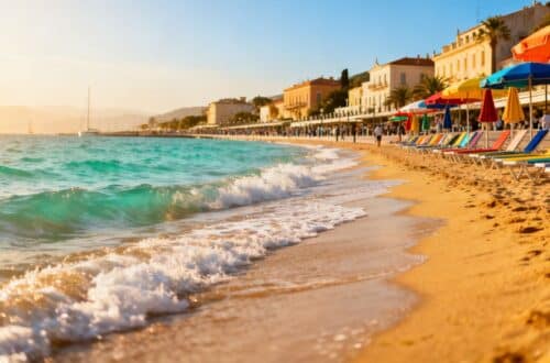 Sunny European beach with clear blue water.