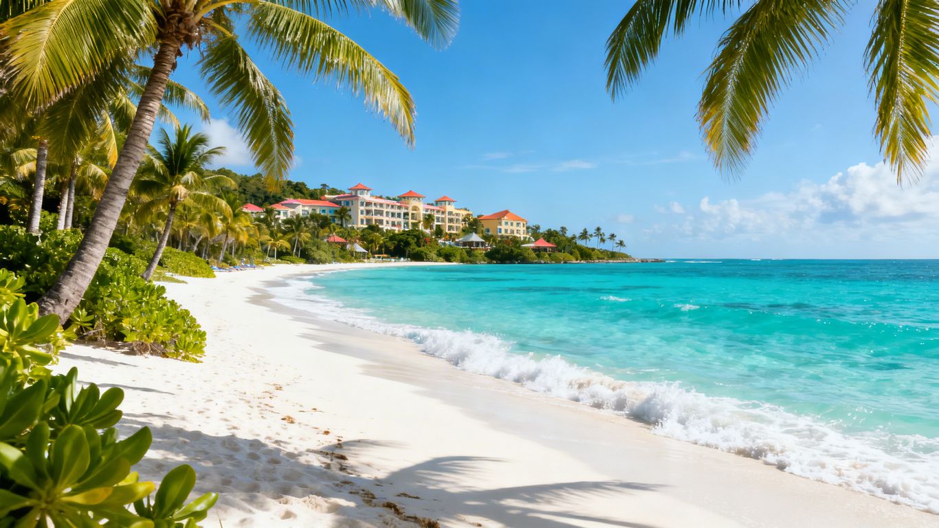 Tropical beach with palm trees and resort.
